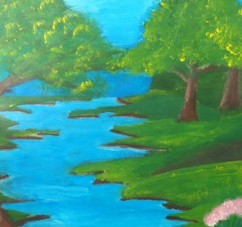Green trees on a grassy riverbank, with a blue river