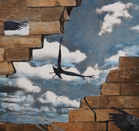 A red brick wall with a hold in the middle, showing a black bird flying against a blue sky with clouds