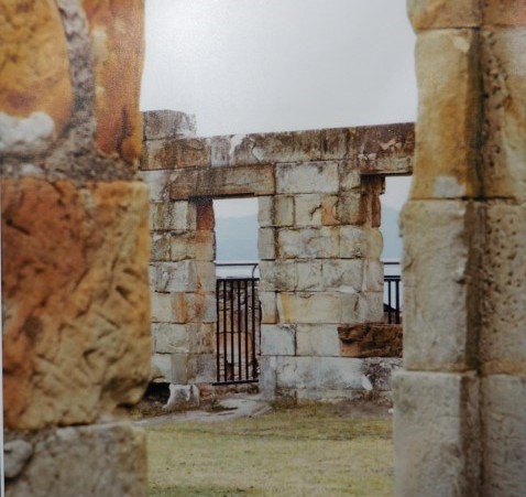 Colour photograph of yellow stone ruins