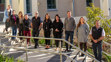 Justice staff standing on stairs